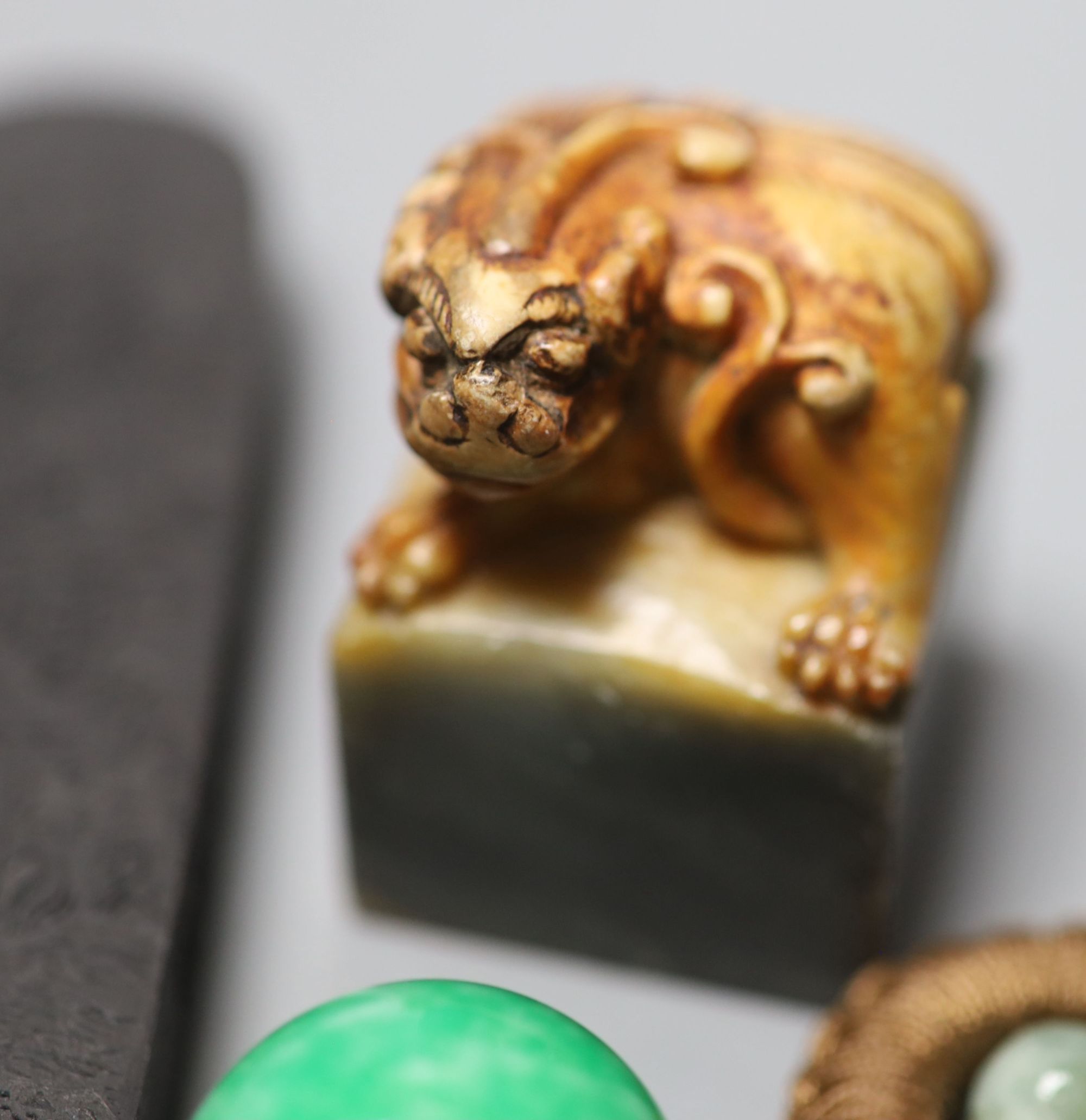 Assorted Chinese small items including two Chinese inkstones, a similar hardstone seal and pendant